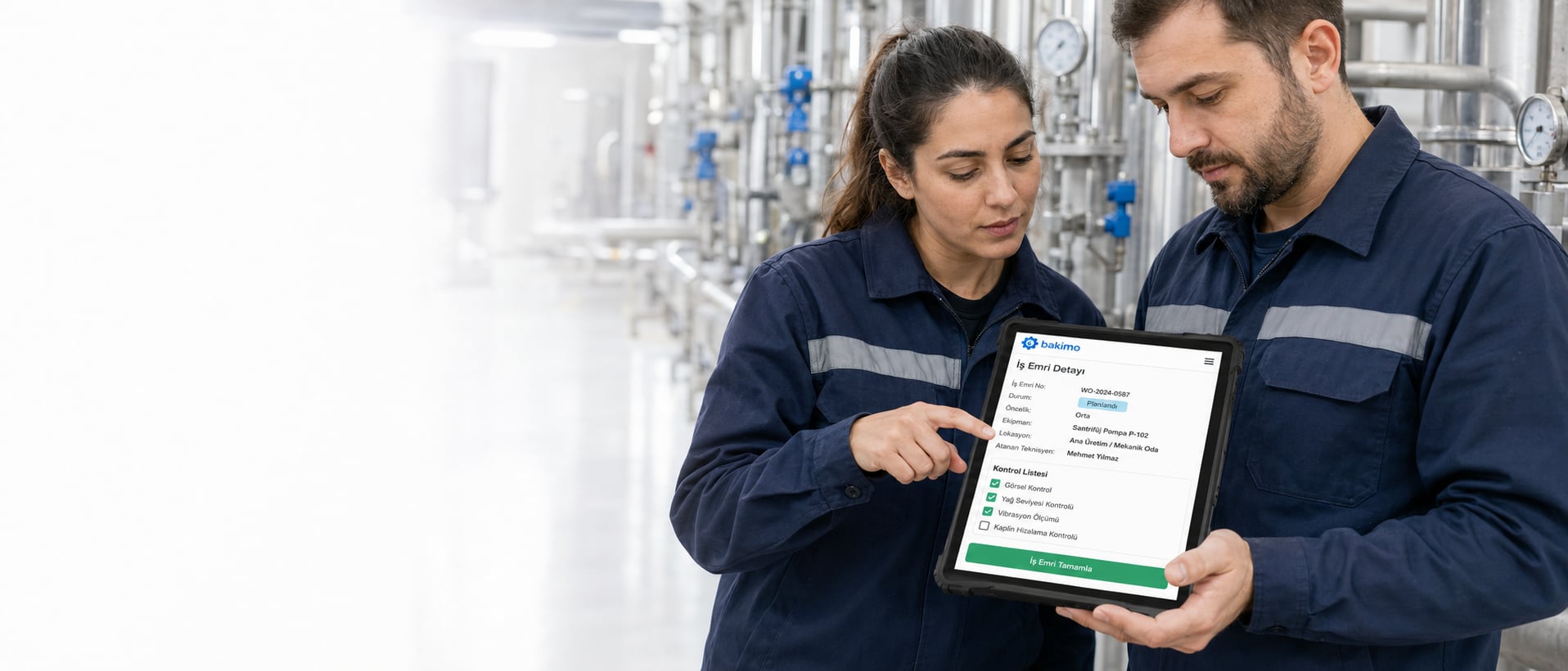 Maintenance technicians reviewing a work order on a tablet with bakimo